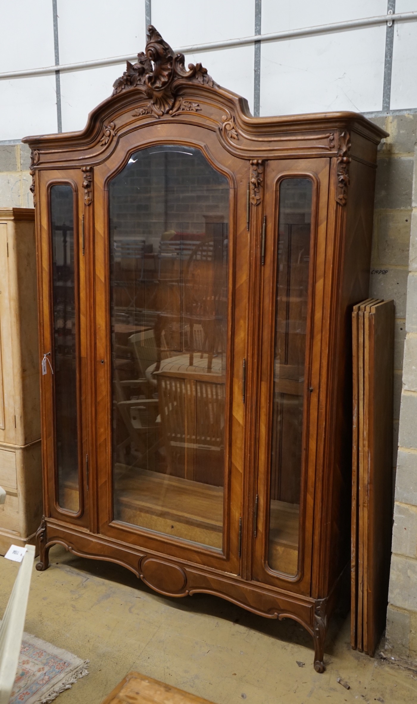 An early 20th century French glazed walnut vitrine, width 160cm, depth 48cm, height 250cm